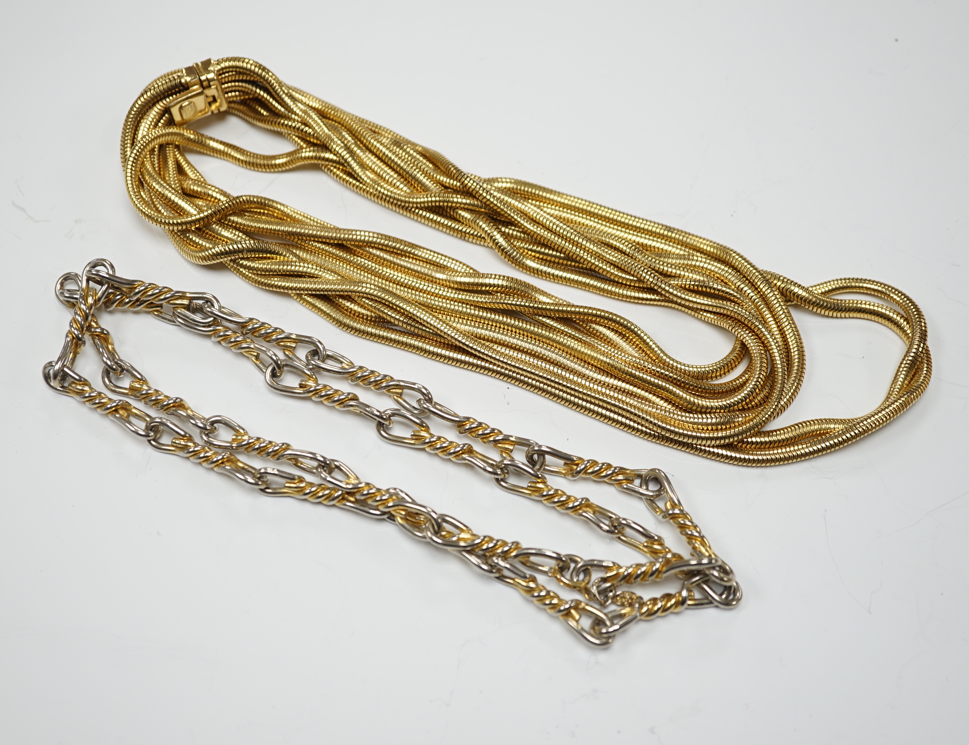 A Christian Dior multi strand gilt metal snake link necklace, 90cm, together with a Christian Dior two colour metal spiral chain link necklace, 78cm, both signed.